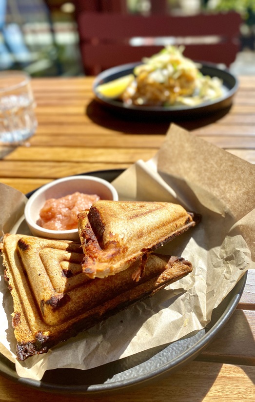 Toasted sandwich with relish on a cafe table