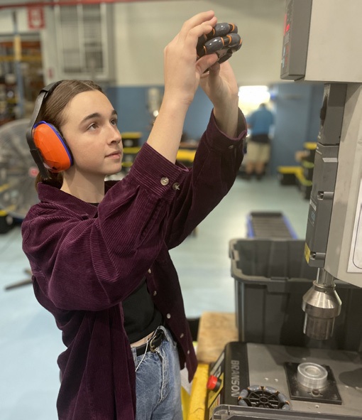Worker operating machinery in the Omnia workshop