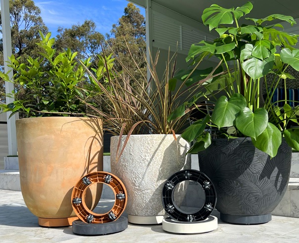 Omnia Plant Glider beneath potted plants on a paved patio