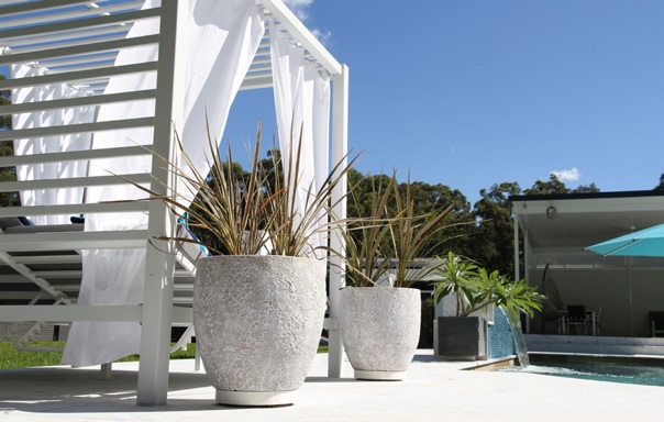 Planter and glider on a stone patio