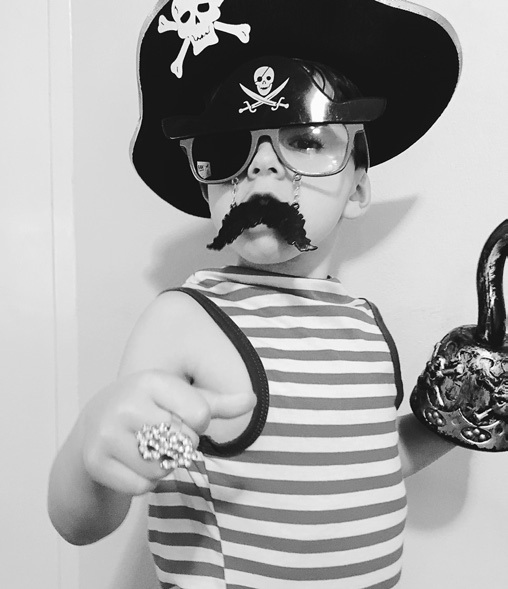 Black and white portrait of a child in a pirate costume